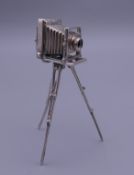 A miniature silver camera. 8.5 cm high.