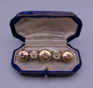 A Victorian unmarked gold, diamond, ruby and sapphire brooch. 5.5 cm wide. 7.9 grammes total weight.