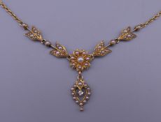 A seed pearl and diamond set pendant necklace. 8.9 grammes total weight.