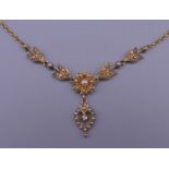 A seed pearl and diamond set pendant necklace. 8.9 grammes total weight.