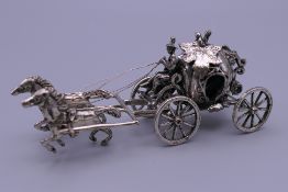 An 800 silver miniature model of the horse and carriage from Cinderella. 10 cm long. 50 grammes.