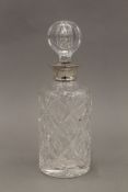 A silver collared cut glass decanter. 27 cm high.