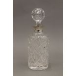 A silver collared cut glass decanter. 27 cm high.