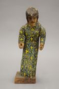 A 17th/18th century painted religious figural carving mounted on a later plinth base. 28 cm high.