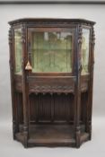 A 19th century carved oak glazed cabinet. 120 cm wide.