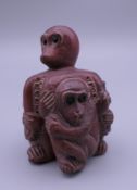 A carved wooden netsuke formed as monkeys. 5 cm high.