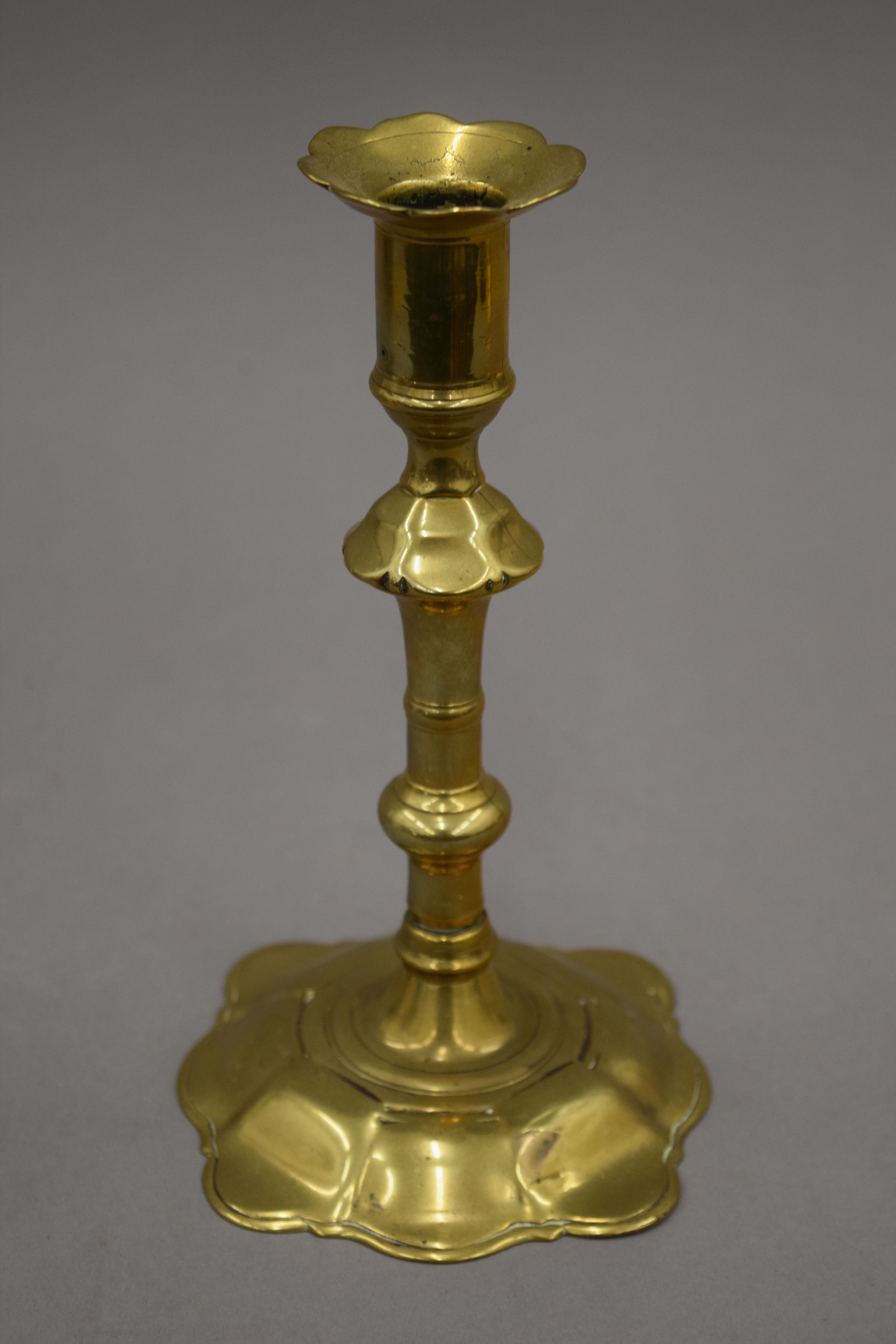 An 18th century brass candlestick with petal edge drip pan and base, - Image 6 of 9