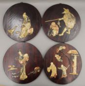 A set of four Chinese hardstone inset wooden plaques. Each 24.5 cm diameter.