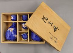 A boxed Japanese porcelain sake set.