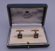 A pair of unmarked 18 ct gold, diamond and sapphire cufflinks. 1 cm square. 10.