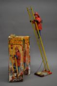 Two boxed vintage climbing firemen toys. The boxes 31.5 cm high.