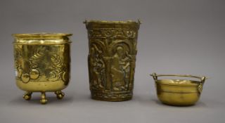 An embossed brass Holy Water vessel with figures in arches,