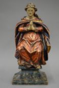 A late 17th/early 18th century polychrome painted carved wooden virgin with hands in prayer.