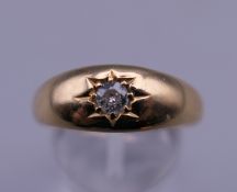 An 18 ct gold diamond gypsy set ring. Ring size U/V. 4.1 grammes total weight.