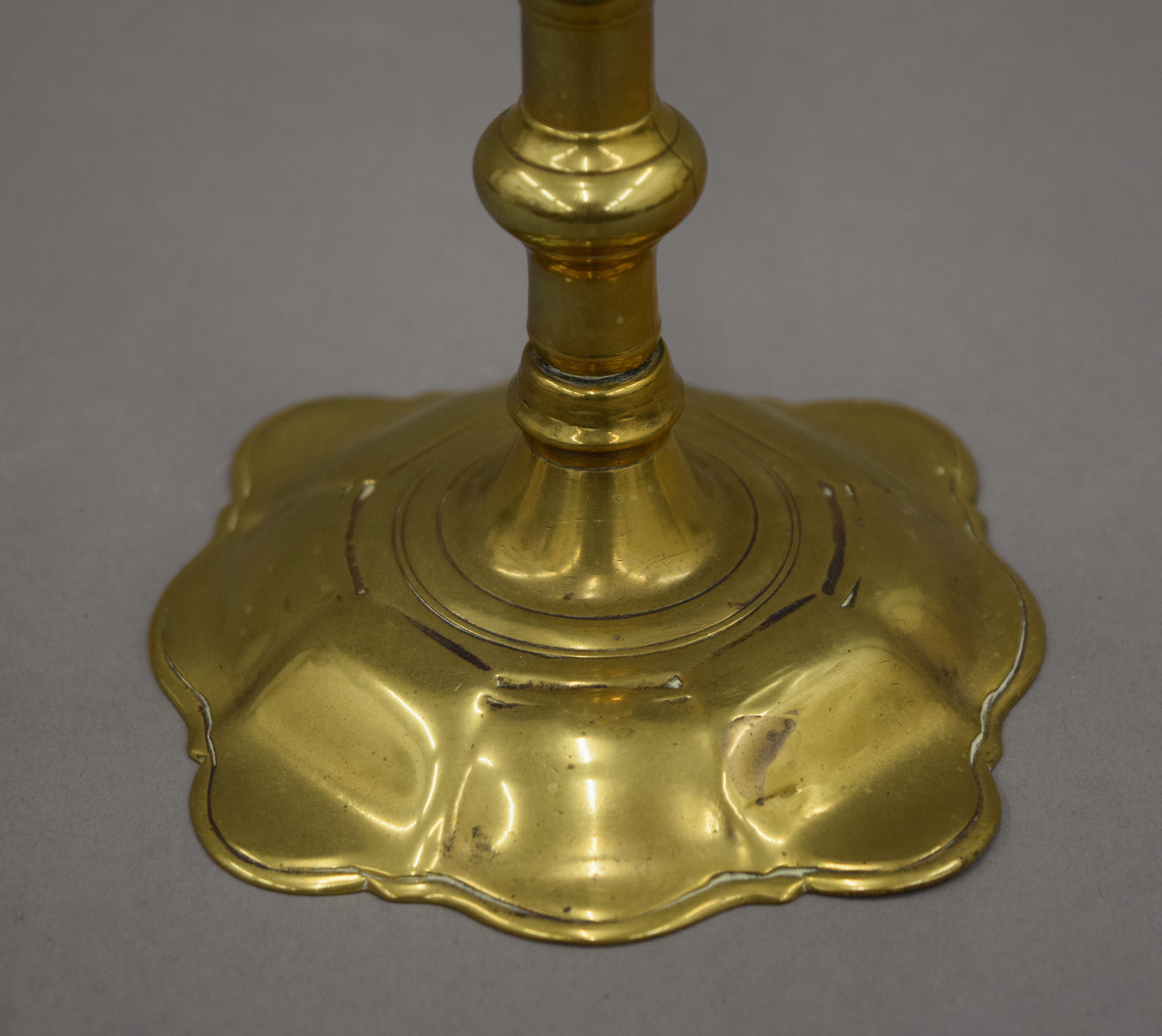 An 18th century brass candlestick with petal edge drip pan and base, - Image 9 of 9