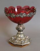 A cranberry tazza with unmarked silver mounts. 23 cm high.