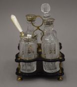 A 19th century papier mache cruet stand with silver plated mounted fittings. 19 cm high overall.