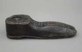 An unusual antique stone model of a shoe, possibly an implement of some kind. 16.5 cm long.