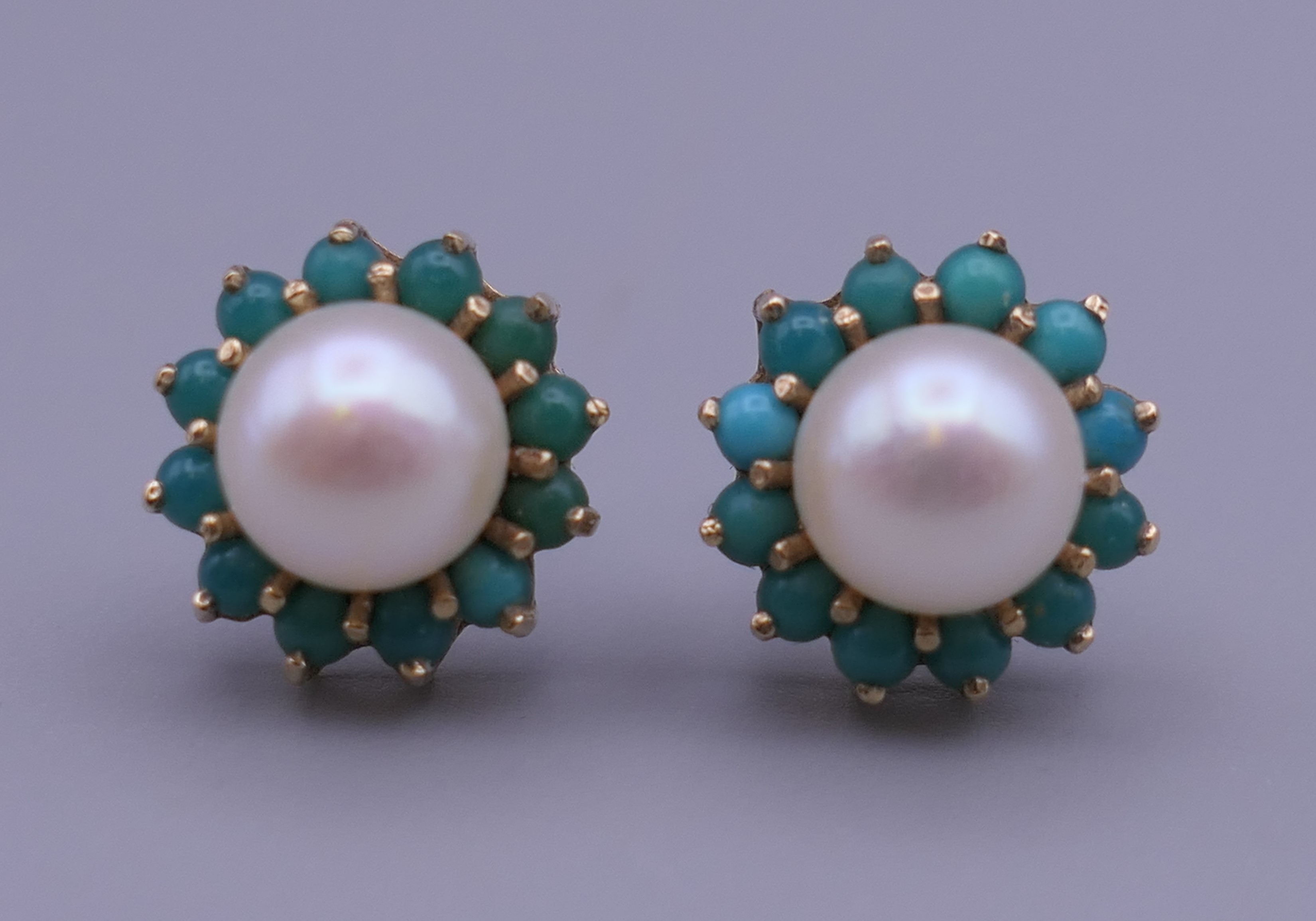 A pair of 9 ct gold turquoise and pearl earrings, each with replaced silver backs. 1 cm diameter.