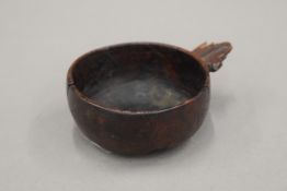 An antique treen wine taster. 9 cm wide.