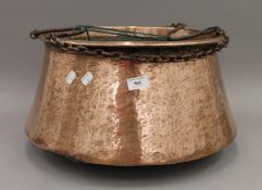 A large 19th century copper cauldron/log bin with chains. 43 cm diameter.