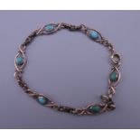 A 9 ct gold and turquoise bracelet. 18 cm long. 7.7 grammes total weight.