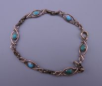 A 9 ct gold and turquoise bracelet. 18 cm long. 7.7 grammes total weight.