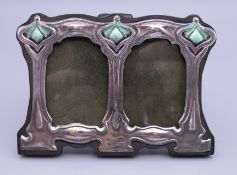 An Art Nouveau style silver double photograph frame. 11 cm wide.