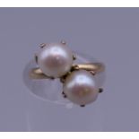 A pearl crossover ring. Ring size J.