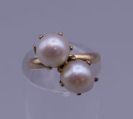 A pearl crossover ring. Ring size J.