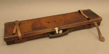 A leather shotgun case, initialled WJS. 76 cm long.