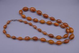 A bead necklace, possibly amber. Approximately 98 cm long.