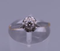 An 18 ct gold and platinum diamond solitaire ring. Ring size K/L. 1.9 grammes total weight.