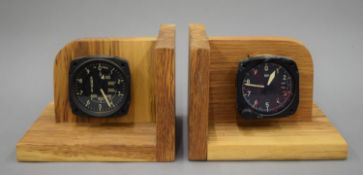 A pair of bookends inset with altimeters. Each 20 cm wide.