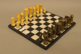 A vintage chess set, possibly American, together with a chess board.