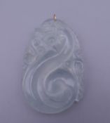A icy jade pendant with a gold suspension loop. 5.5 cm high.