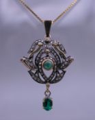 An unmarked gold rose cut diamond and emerald pendant on a silver gilt chain. The pendant 3.