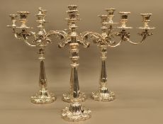 A set of four Old Sheffield plate adaptable candelabra. 51.5 cm high.