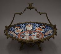 A 19th century Imari dish with elaborate bronze mount. 32 cm diameter.