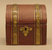 A Victorian brass bound dome shaped leather casket containing two cut glass scent bottles.