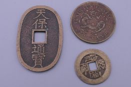 Three vintage Chinese coins.