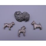 A Kenart dog form brooch and three dog pendants. The former 3.5 cm wide.