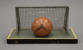 An early/mid-20th century novelty clock formed as a football and goal net. 22 cm wide.