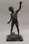 A patinated bronze model of a young boy with a bat and ball, indistinctly signed,