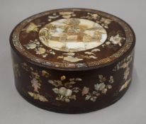 A late 19th/early 20th century Chinese mother-of-pearl inlaid circular box. 25.5 cm diameter.