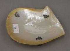 An abalone shell with butterfly mounts. 19 cm long.