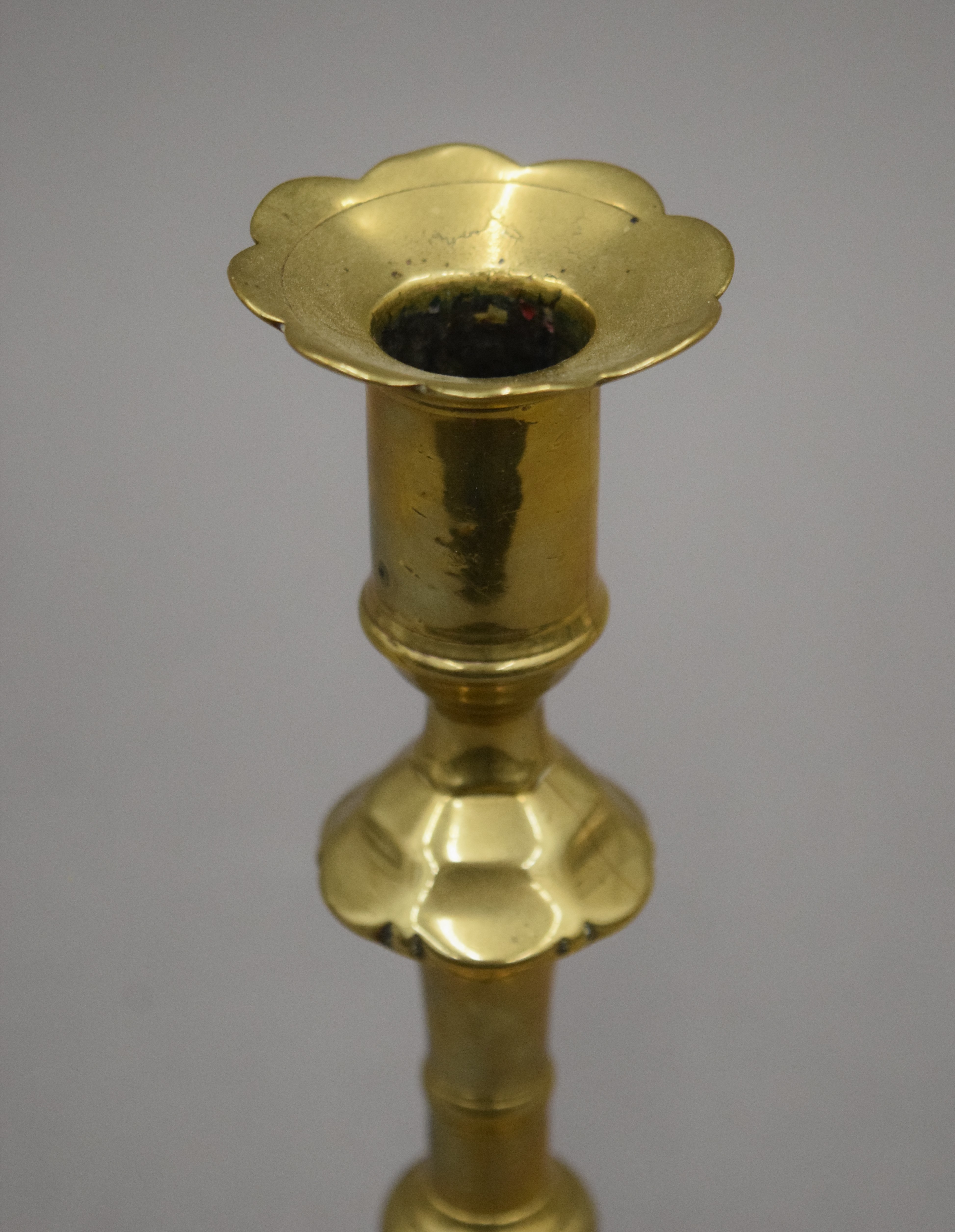 An 18th century brass candlestick with petal edge drip pan and base, - Image 8 of 9