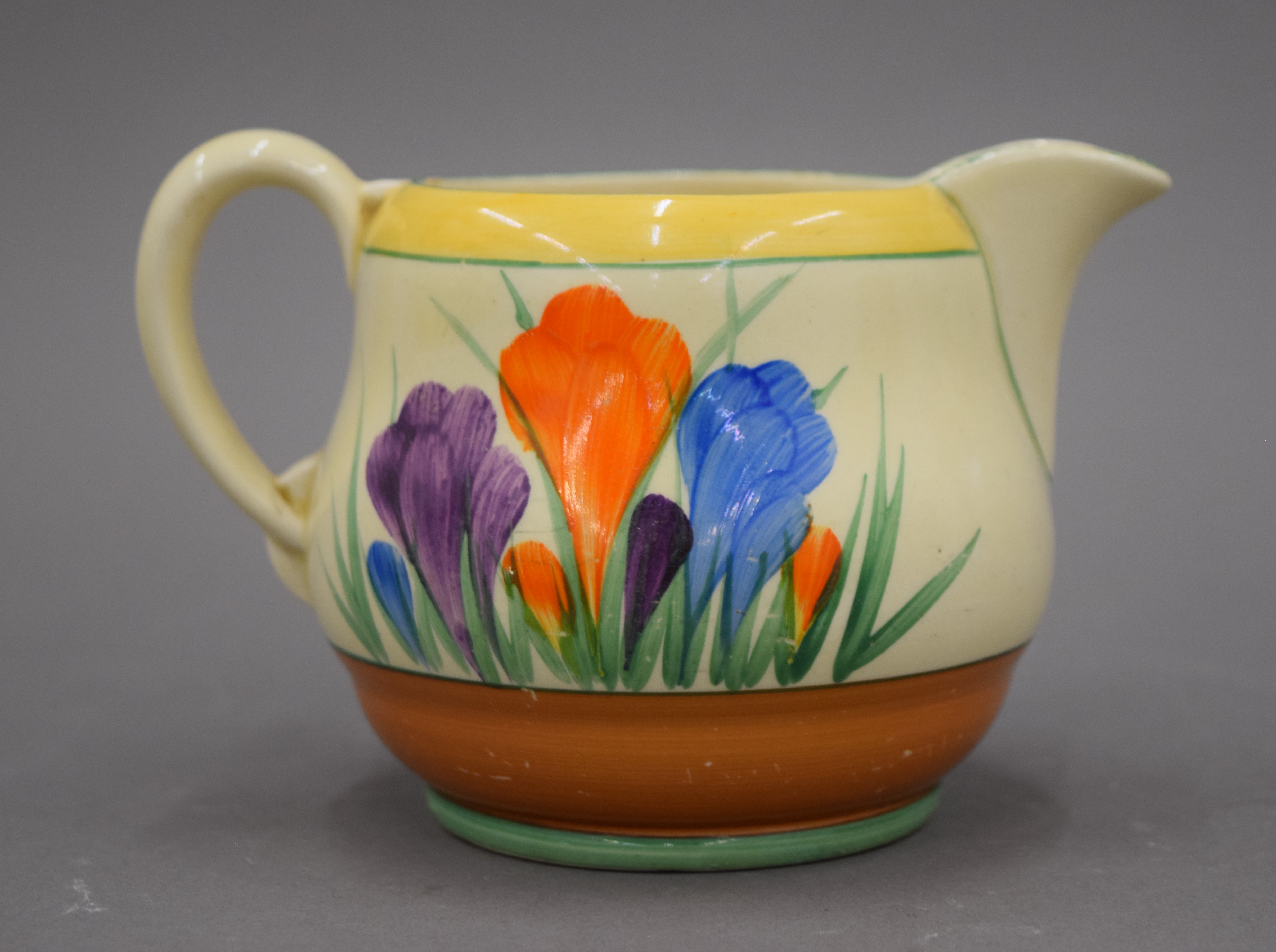 Three Clarice Cliff Crocus pattern jugs. The largest 12.5 cm high. - Image 5 of 8