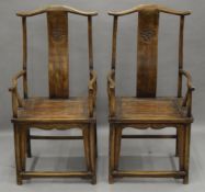 A pair of Chinese elm open armchairs. 59 cm wide.