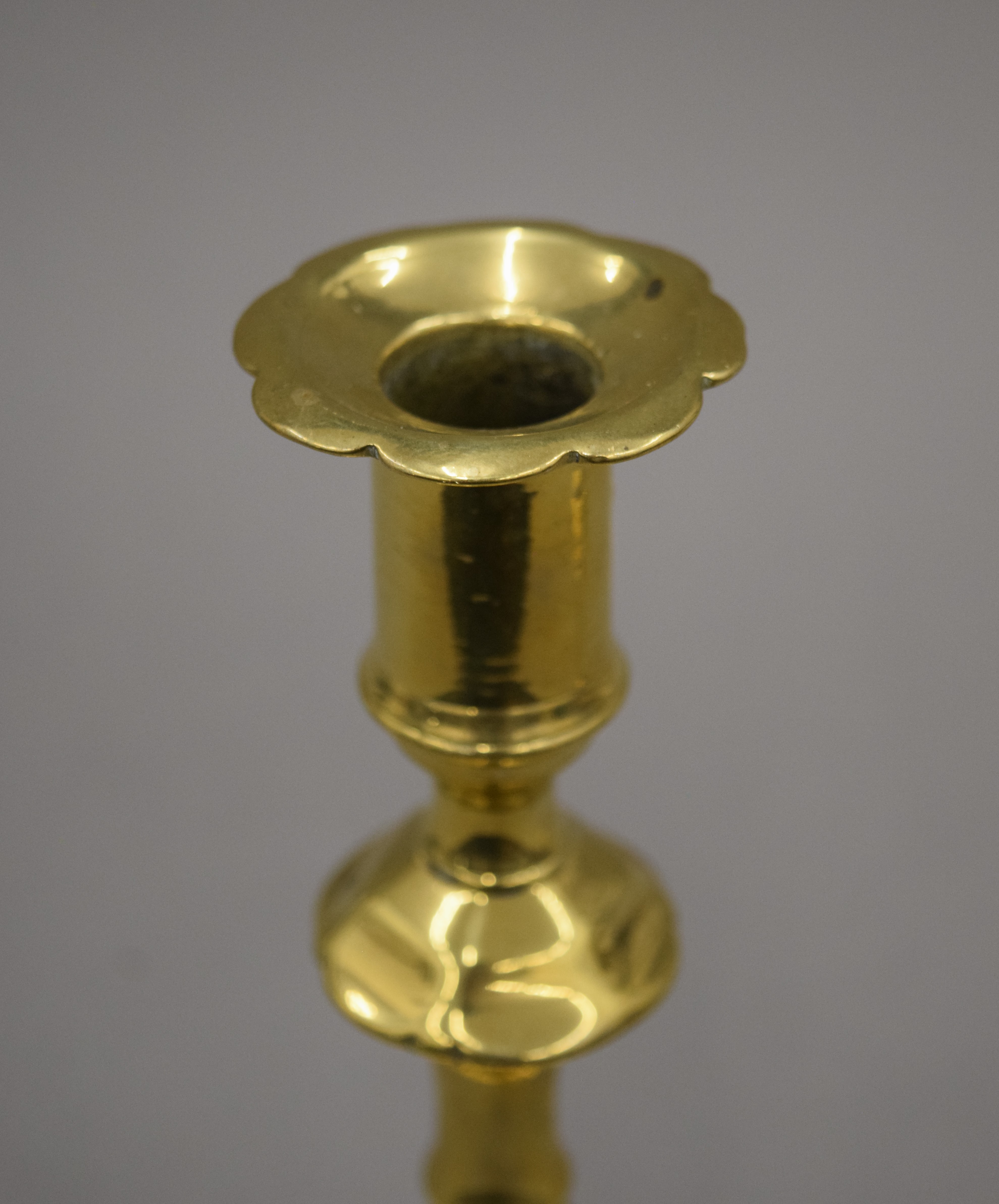 An 18th century brass candlestick with petal edge drip pan and base, - Image 4 of 9